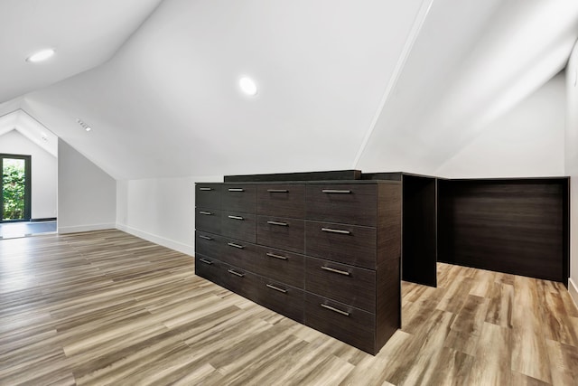 bonus room with vaulted ceiling and light hardwood / wood-style flooring