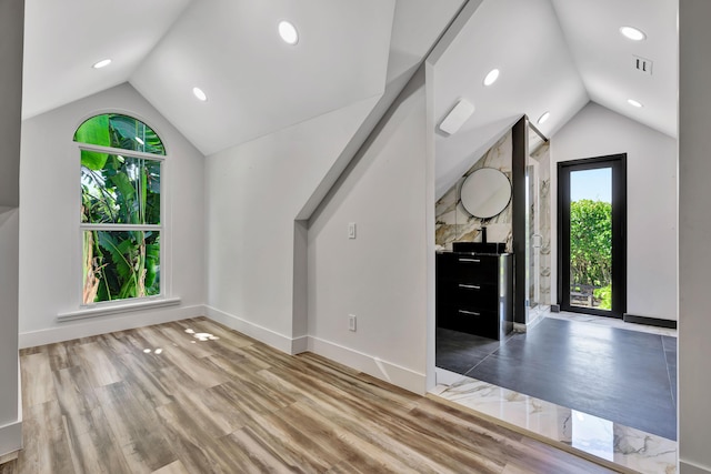 bonus room featuring hardwood / wood-style flooring and vaulted ceiling