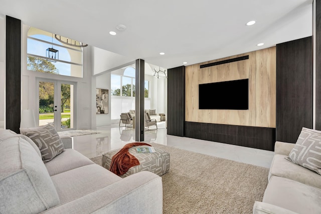 living room with french doors and wood walls