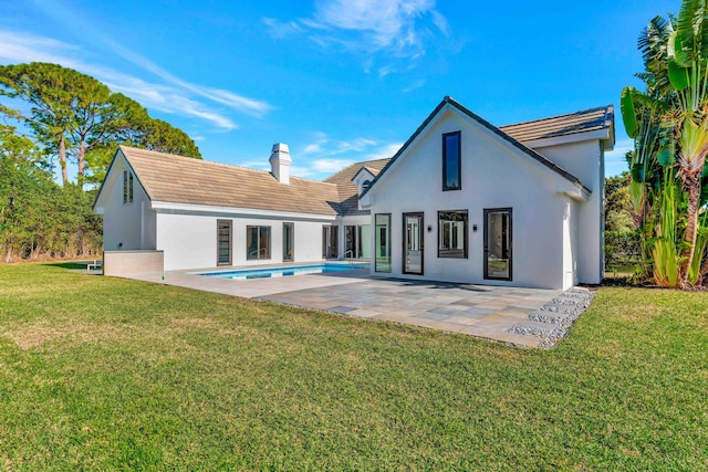 back of house with a yard and a patio area