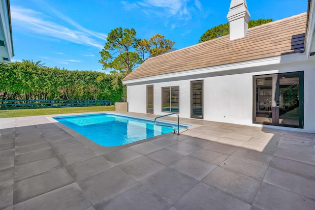 view of swimming pool with a patio area