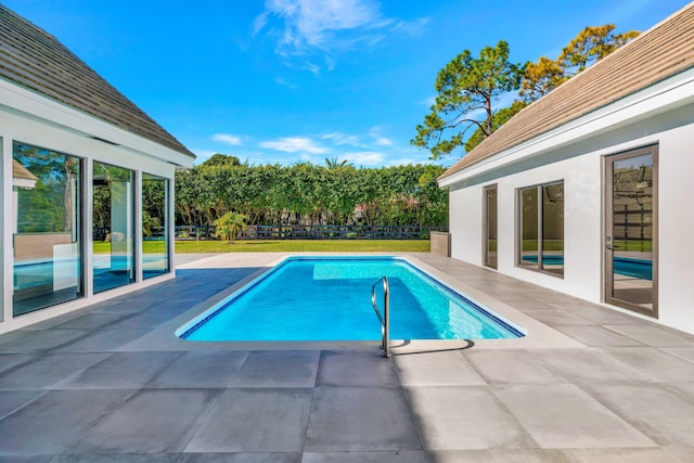 view of swimming pool with a patio