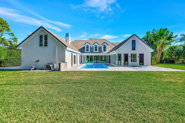 back of property featuring a fenced in pool, a patio, cooling unit, and a lawn