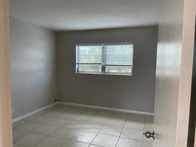 spare room featuring light tile patterned floors