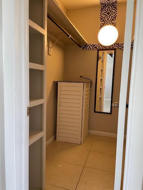 spacious closet with tile patterned floors