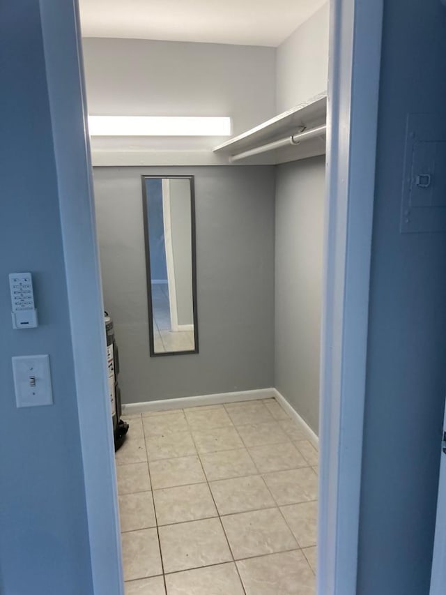 spacious closet featuring electric panel and light tile patterned floors