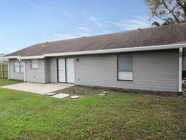 back of house featuring a patio and a lawn