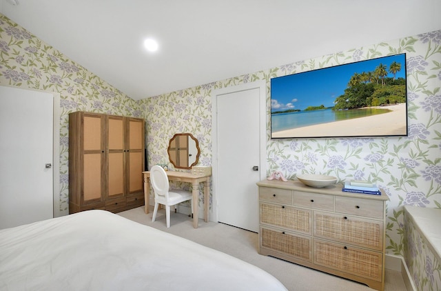 carpeted bedroom with lofted ceiling