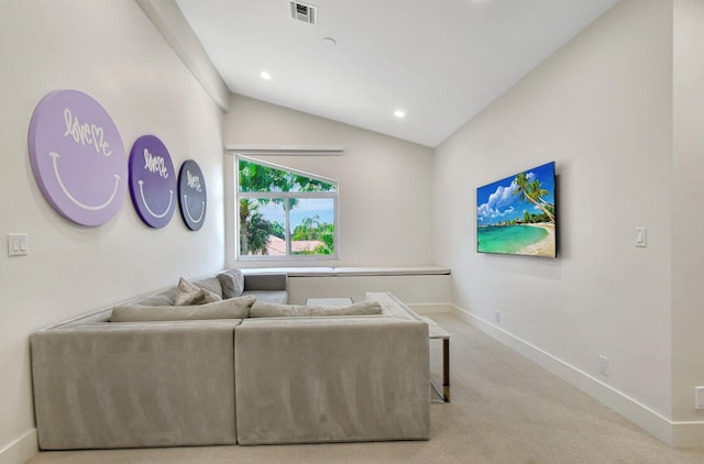 carpeted living room featuring vaulted ceiling