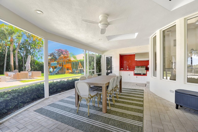 sunroom featuring ceiling fan