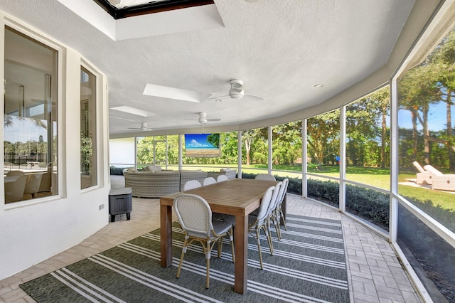 sunroom / solarium featuring ceiling fan