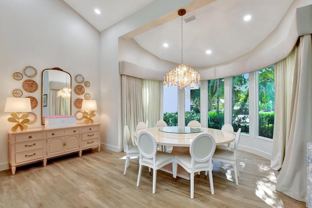 dining space featuring light hardwood / wood-style flooring and a chandelier