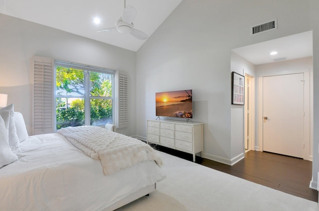 bedroom with dark wood-type flooring, high vaulted ceiling, and ceiling fan