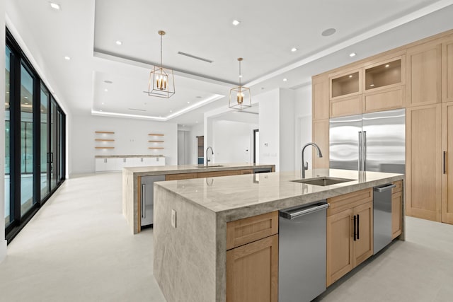 kitchen with pendant lighting, a large island, a raised ceiling, and sink