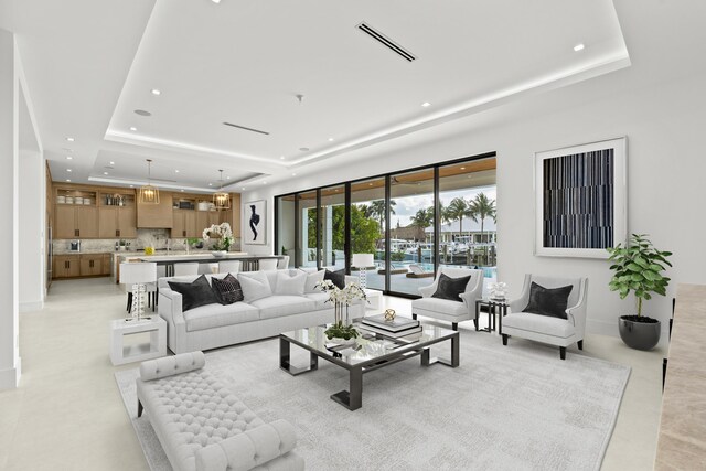 unfurnished living room featuring sink and a tray ceiling