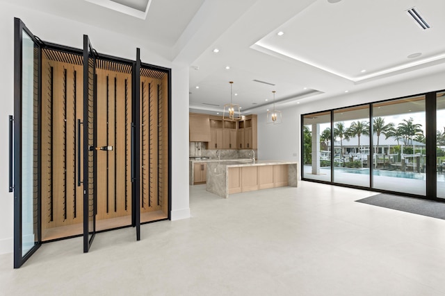 interior space featuring a tray ceiling and sink