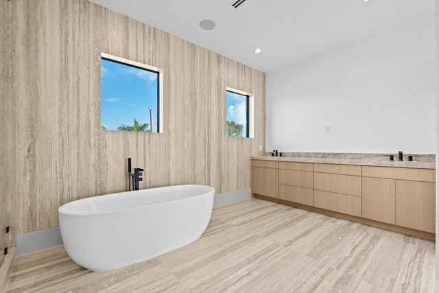 empty room with a tray ceiling and light hardwood / wood-style floors