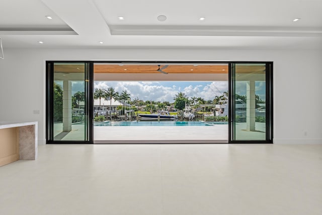 doorway to outside featuring a tray ceiling