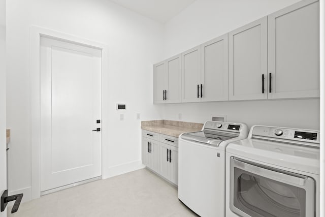 laundry room with cabinets and separate washer and dryer