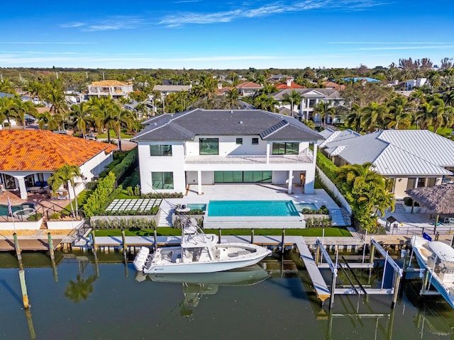 back of property featuring a patio and a water view