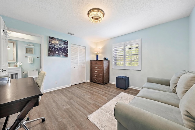 office area with hardwood / wood-style flooring and a textured ceiling