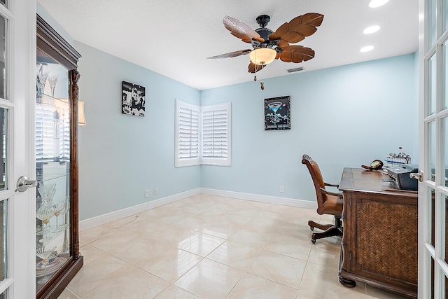 home office with plenty of natural light, light tile patterned floors, and ceiling fan