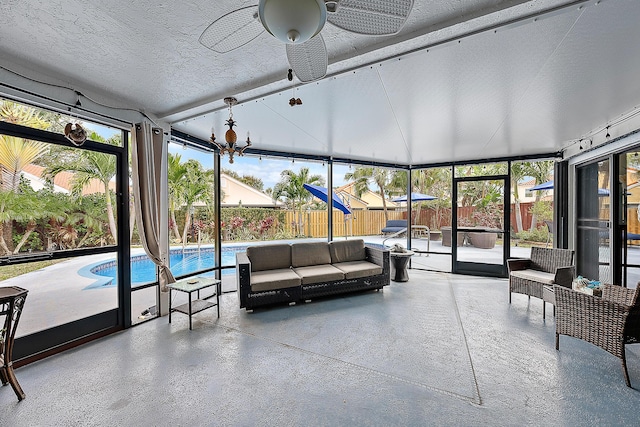 sunroom featuring ceiling fan