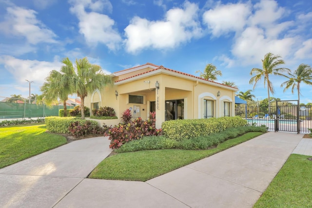 view of front of home featuring a community pool and a front lawn