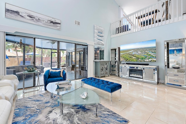 living room with light tile patterned flooring and a towering ceiling