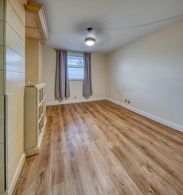 spare room with light hardwood / wood-style flooring