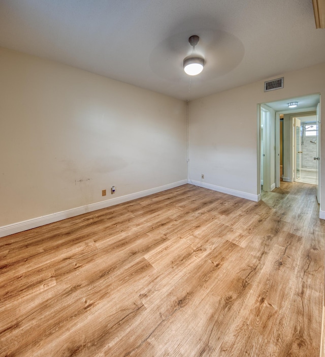 spare room featuring ceiling fan and light wood-type flooring