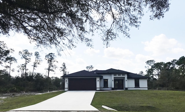 view of front of house featuring a garage and a front lawn