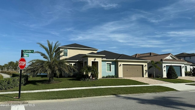 view of front of property featuring a garage and a front lawn