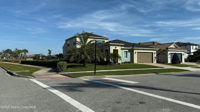 view of front of property with a garage and a front lawn