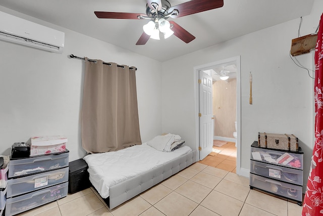 bedroom featuring a wall mounted air conditioner, light tile patterned floors, and ceiling fan