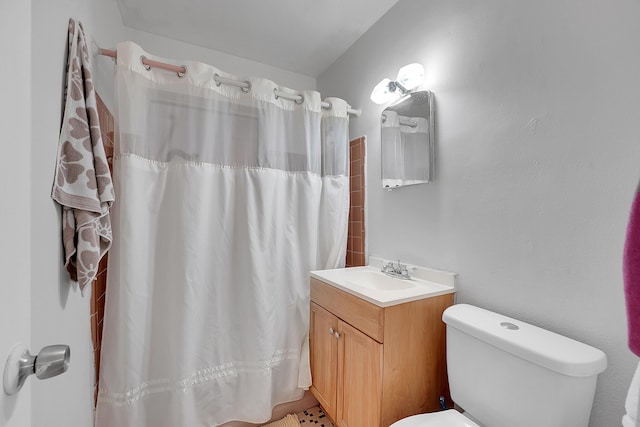 bathroom featuring vanity, curtained shower, and toilet