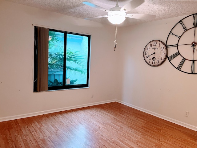 spare room with ceiling fan, a textured ceiling, and light hardwood / wood-style flooring