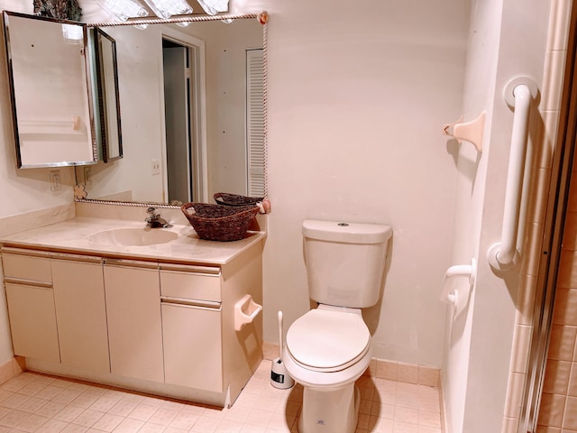 bathroom featuring vanity, tile patterned flooring, and toilet