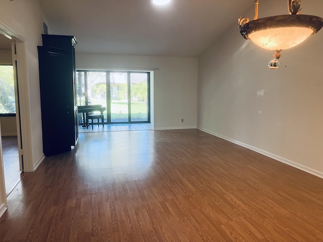 unfurnished room featuring dark hardwood / wood-style flooring