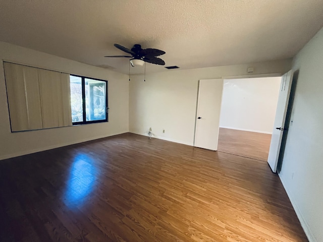 unfurnished room with hardwood / wood-style flooring, ceiling fan, and a textured ceiling