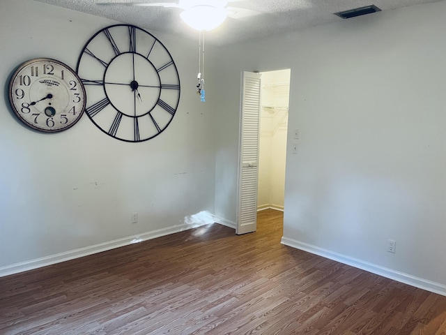 interior space with ceiling fan, hardwood / wood-style floors, and a textured ceiling