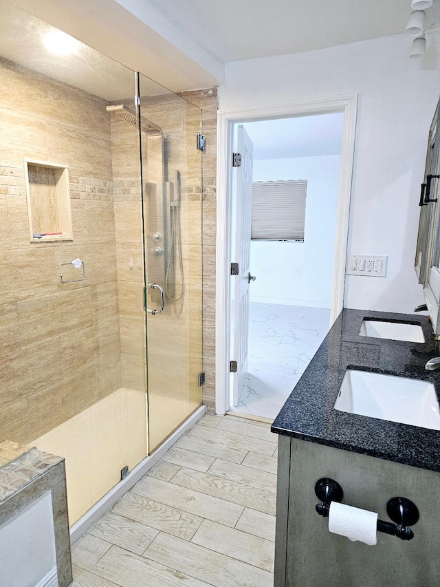 bathroom with vanity and a shower with shower door