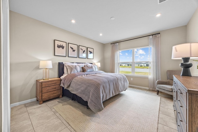 bedroom with recessed lighting, light tile patterned flooring, and baseboards