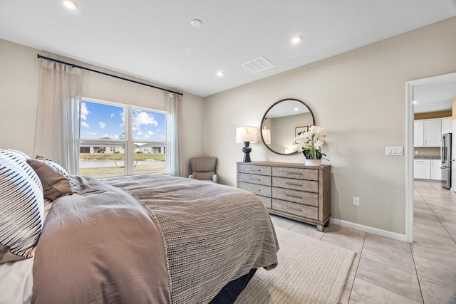 bedroom featuring recessed lighting, visible vents, freestanding refrigerator, light tile patterned flooring, and baseboards