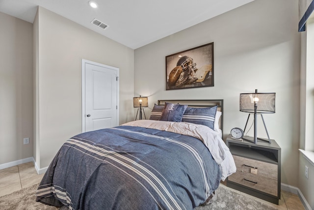 bedroom with visible vents, baseboards, and light tile patterned flooring