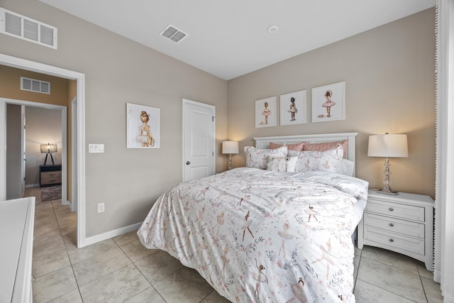 bedroom featuring light tile patterned flooring, visible vents, and baseboards