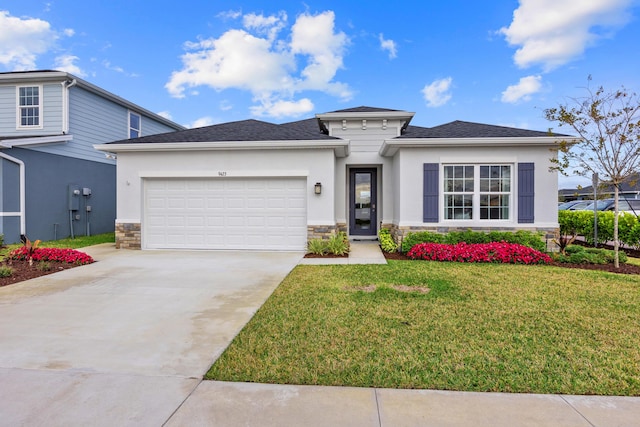 prairie-style home featuring stucco siding, concrete driveway, a garage, stone siding, and a front lawn