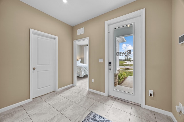 foyer entrance featuring visible vents, baseboards, and light tile patterned floors