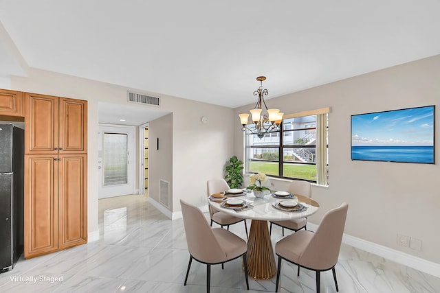 dining room with a chandelier, marble finish floor, visible vents, and baseboards