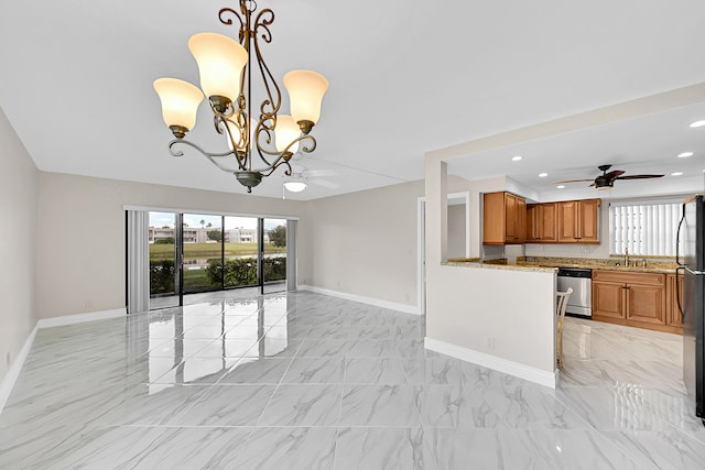 kitchen featuring dishwasher, marble finish floor, open floor plan, and brown cabinets